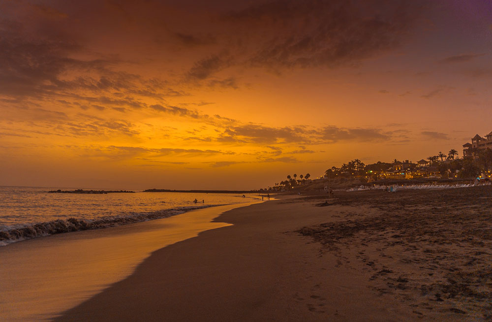 Playa del Duque at Costa Adeje in Tenerife, Spain at sunset.