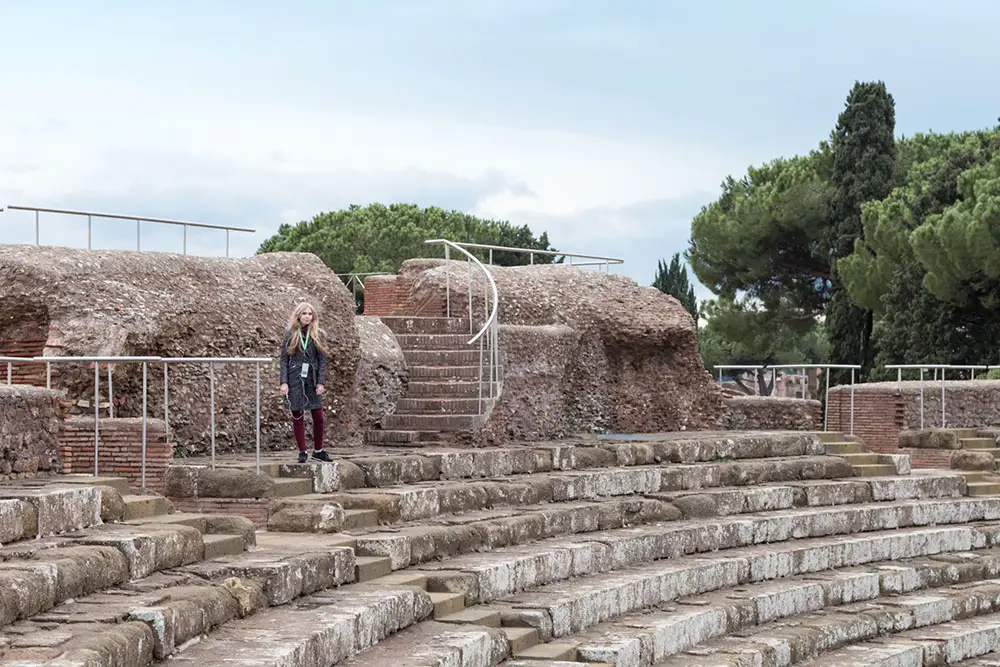 Listening to the audio guide at Ostia Antica in Rome