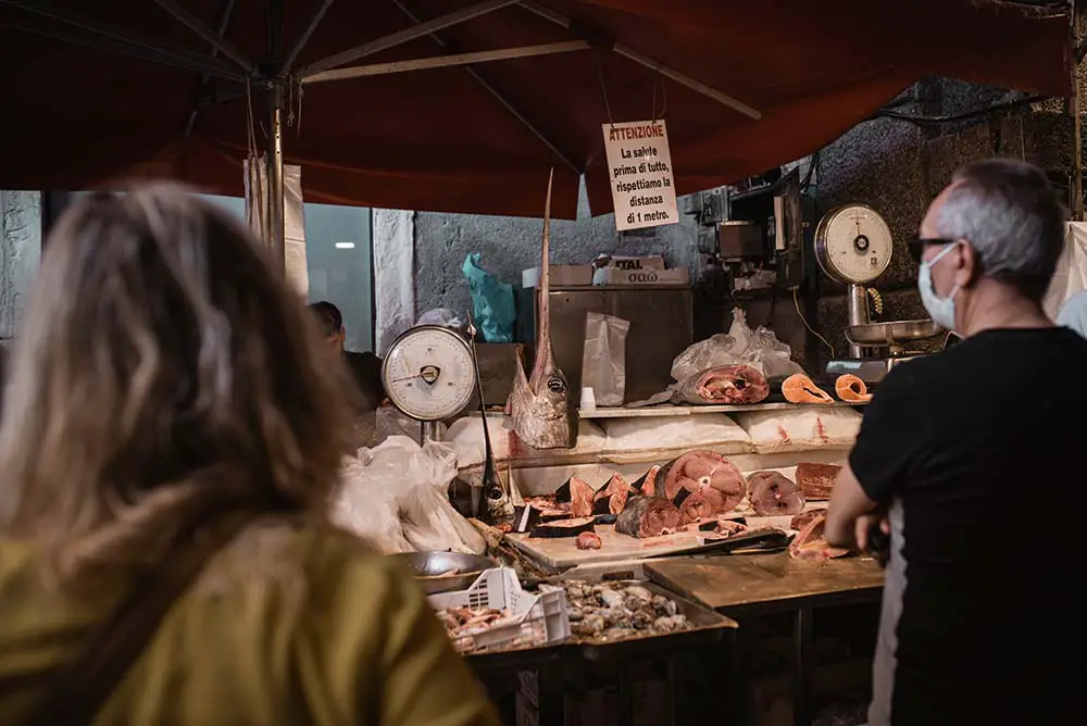 The fish market in Catania bustling with commerce.